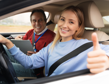 Driving school car merging safely onto a high-speed UK motorway.